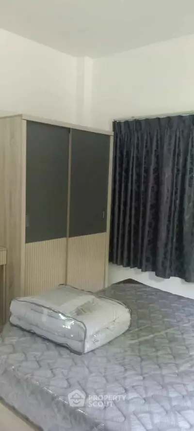 Cozy bedroom with modern wardrobe and elegant curtains