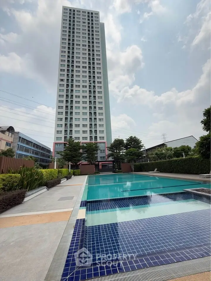 Stunning high-rise building with a luxurious pool, perfect for modern living.