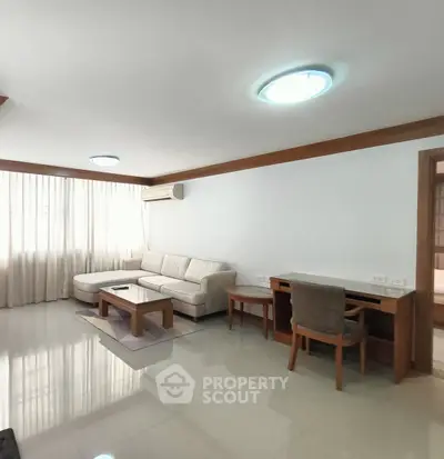 Spacious living room with modern furniture and natural light