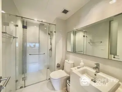 Modern bathroom with glass shower and sleek fixtures