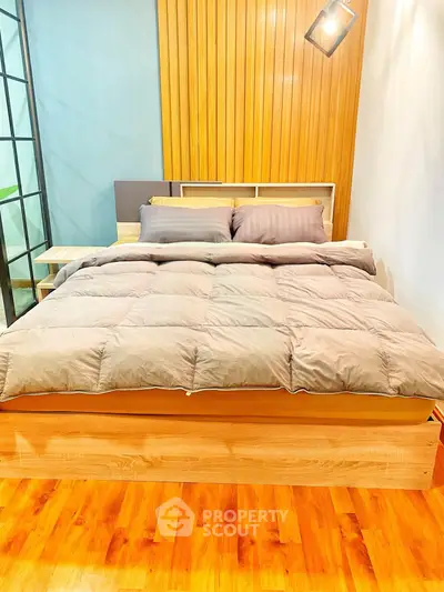 Modern bedroom with stylish wooden accents and cozy bedding