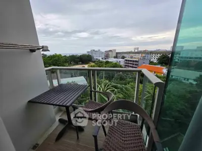 Charming balcony with scenic view of lush greenery and cityscape, perfect for relaxation.