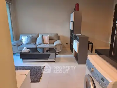 Modern living room with stylish furniture and washing machine, perfect for urban living.