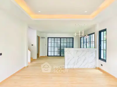 Spacious modern living room with open layout and elegant lighting