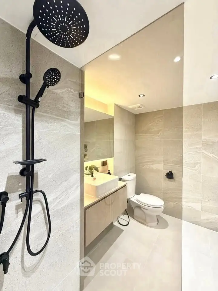 Modern bathroom with sleek shower and elegant fixtures in luxury real estate property.