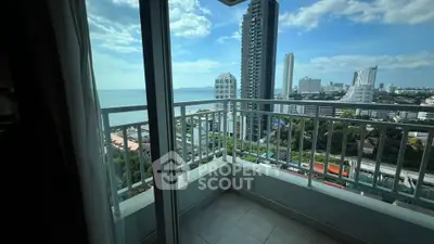 Stunning high-rise balcony view overlooking cityscape and ocean, perfect for urban living.