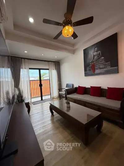 Stylish living room with wooden furniture and balcony access, perfect for relaxation and entertaining.