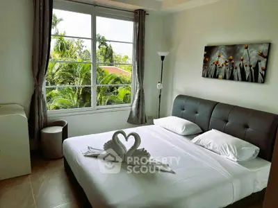 Elegant bedroom with large window and lush garden view, featuring stylish decor and cozy ambiance.