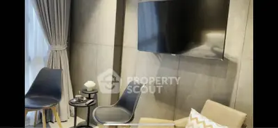 Modern living room with sleek TV and stylish seating