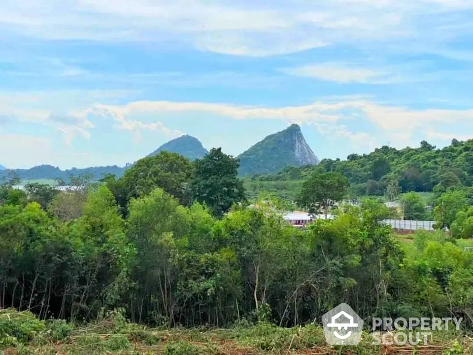 Scenic land plot with lush greenery and mountain views, perfect for development or investment opportunities.