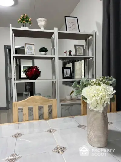 Modern dining area with stylish decor and open shelving