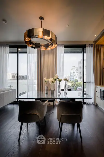 Luxurious modern dining area with city view, elegant chandelier, and floor-to-ceiling windows.