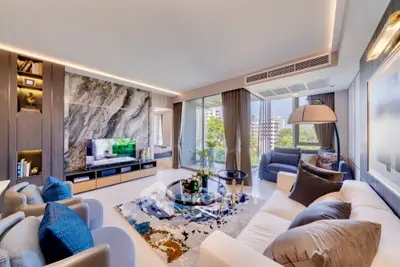 Luxurious modern living room with elegant decor and large windows offering a stunning city view.