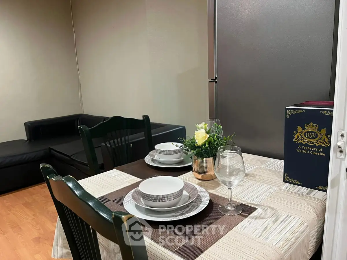 Cozy dining area with elegant table setting and modern decor in a stylish apartment.