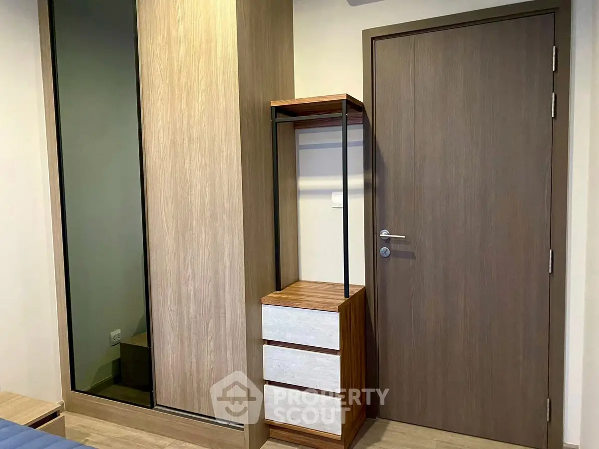 Modern bedroom with sleek wooden wardrobe and stylish dresser