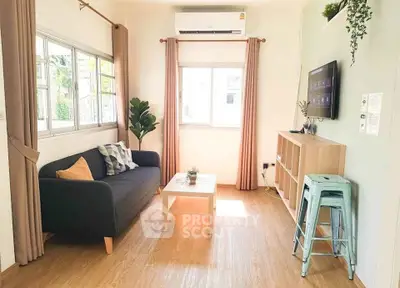 Charming living room with natural light, modern decor, and cozy seating area.