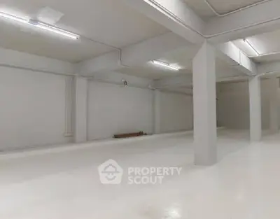 Spacious industrial-style storage space with high ceilings and ample lighting.