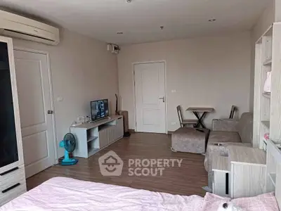Modern studio apartment with cozy living area and stylish furniture, perfect for urban living.