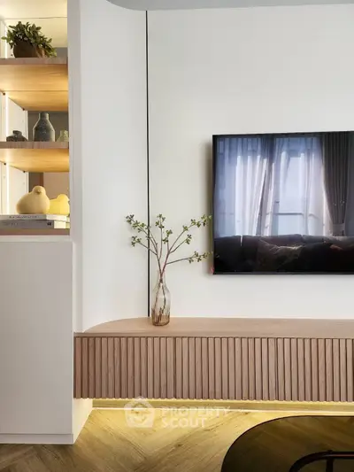 Modern living room with stylish wooden TV console and decorative shelving