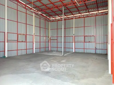 Spacious industrial warehouse with high ceilings and metal framework