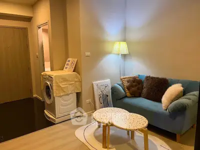 Cozy living room with modern decor and washing machine in apartment