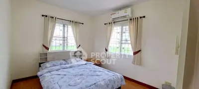 Cozy bedroom with natural light and air conditioning, ideal for restful nights.