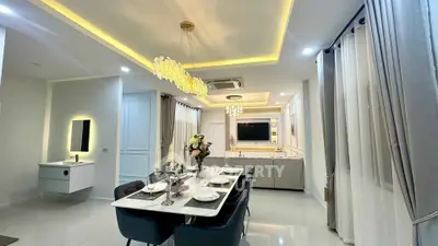 Luxurious open-plan living and dining area with modern lighting and elegant decor.