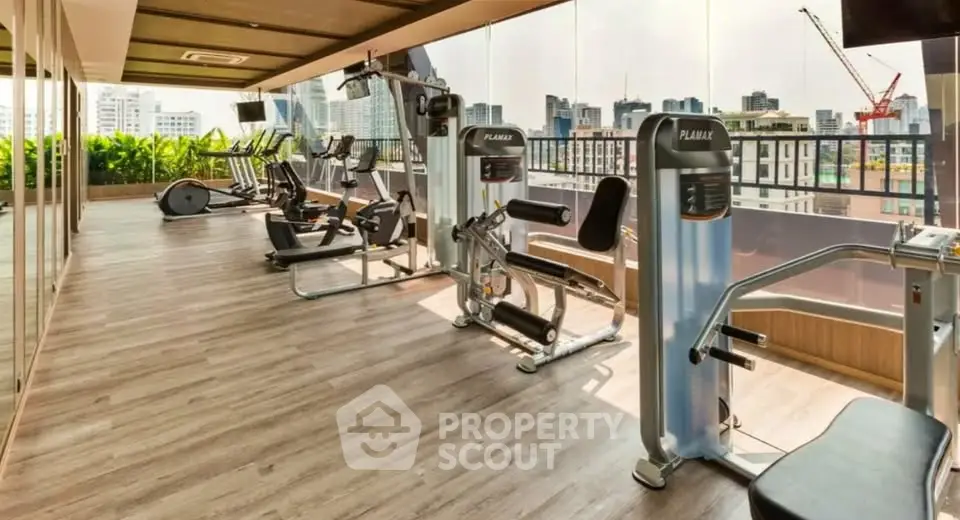 Luxurious high-rise gym with modern equipment and stunning city views.