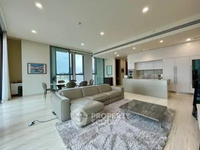 Luxurious open-plan living room with modern kitchen and stunning city view.