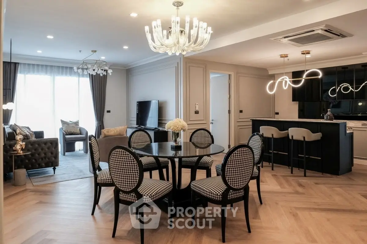 Luxurious open-plan living and dining area with elegant lighting and modern furnishings.