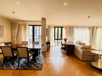 Spacious open-plan living and dining area with elegant decor and natural light