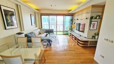 Spacious modern living room with wooden flooring and city view balcony.