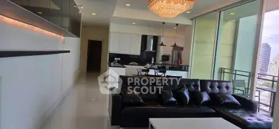 Luxurious open-layout living room with modern kitchen and city view balcony.