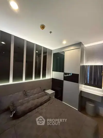 Modern bedroom with sleek design and ambient lighting