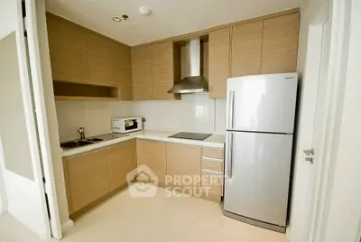 Modern kitchen with sleek cabinetry and stainless steel appliances in a compact layout.