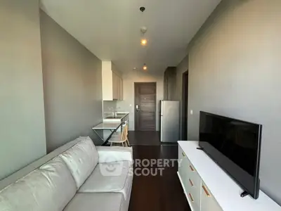 Modern living room with sleek kitchen and stylish furniture in open layout apartment.