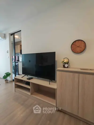 Modern living room with sleek TV setup and stylish wooden cabinet