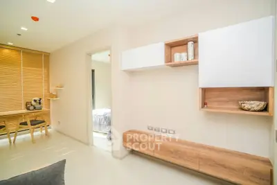 Modern apartment interior with stylish wooden furniture and bright natural lighting.