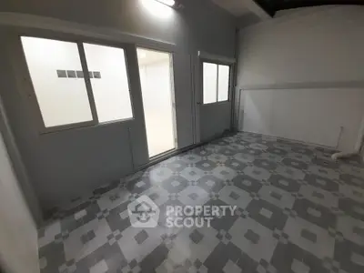 Spacious tiled room with large windows and modern design