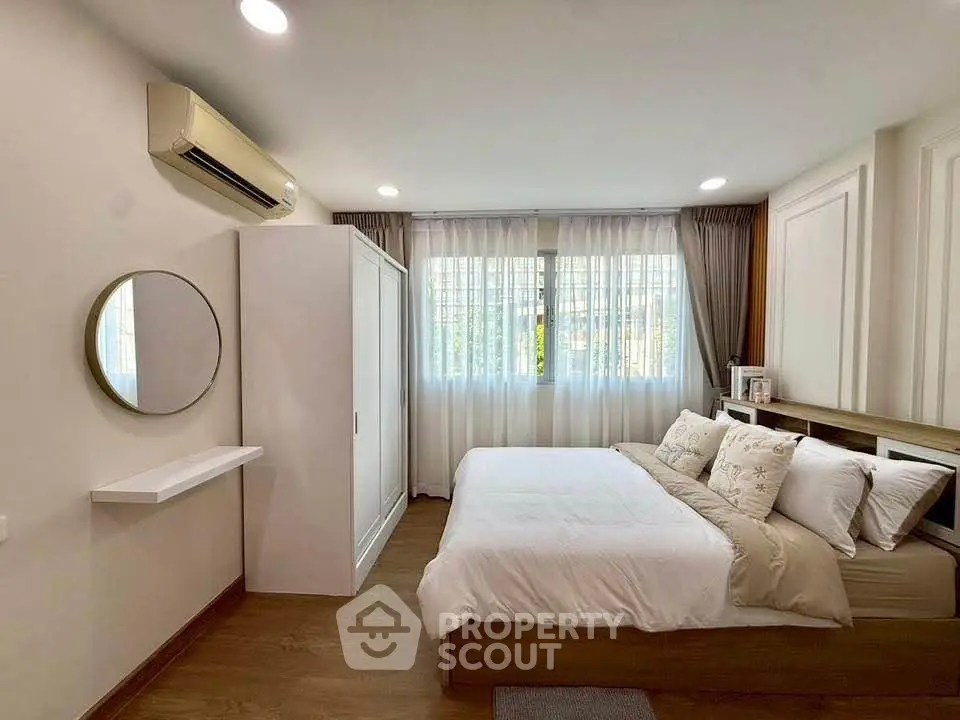 Cozy bedroom with modern decor and ample natural light