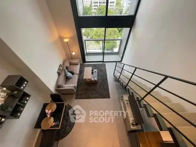Stunning loft apartment with floor-to-ceiling windows and modern interior design.