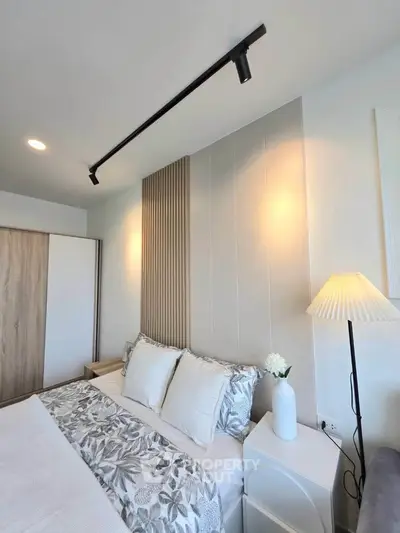 Modern bedroom with stylish decor and cozy ambiance, featuring elegant lighting and a comfortable bed.