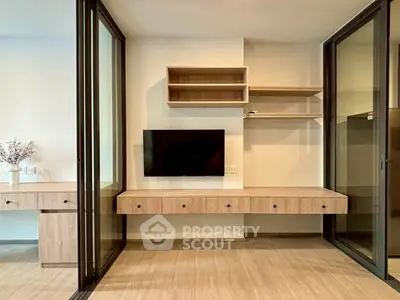 Modern interior with sleek built-in furniture and wall-mounted TV in a stylish apartment.