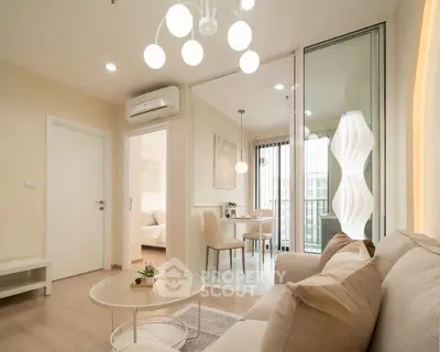 Modern living room with elegant decor and natural light, featuring a cozy seating area and stylish lighting.