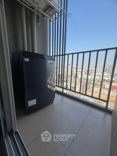 Spacious balcony with city view and compact appliance, ideal for urban living.