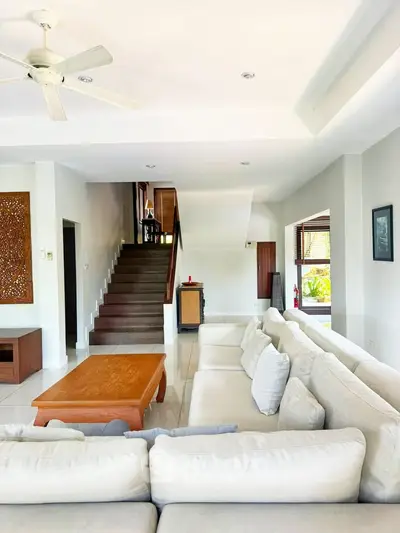 Spacious living room with elegant staircase and cozy seating area