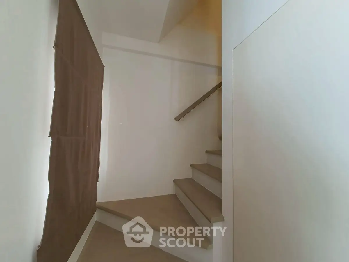 Modern staircase with minimalist design and neutral tones in a contemporary home.