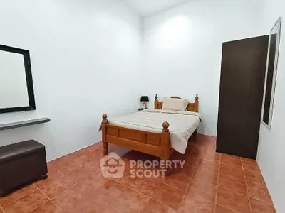 Spacious bedroom with wooden bed frame and minimalist decor