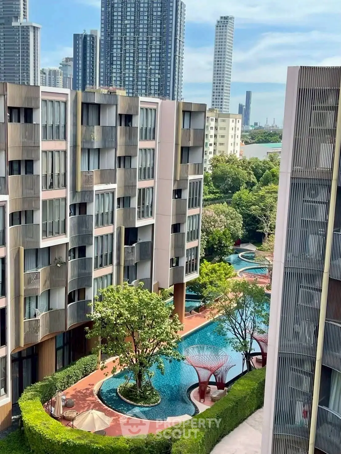 Luxurious urban apartment complex with stunning pool and lush greenery, offering a serene oasis amidst city skyscrapers.