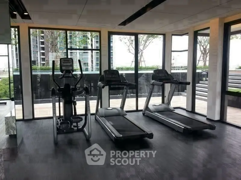 Modern gym with state-of-the-art equipment and panoramic city views.